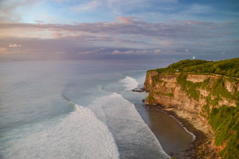 Uluwatu cliffs and ocean waves at sunset