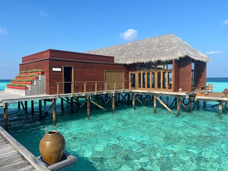 Overwater villa above clear turquoise water