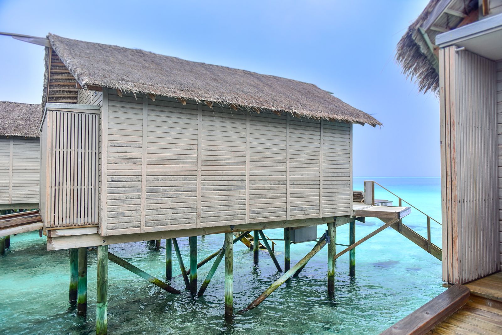 Maldives villa deck over clear water