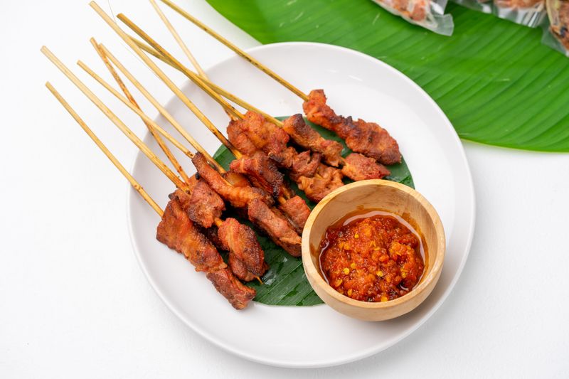 Balinese satay with sambal on a banana leaf