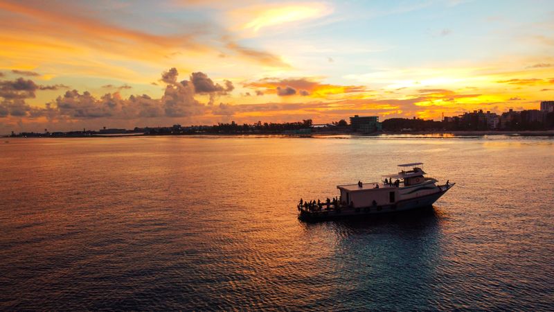Traditional boat on calm water at sunset