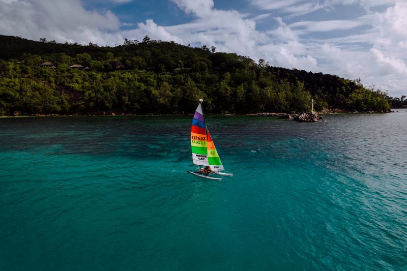 Sailboat on clear turquoise water off the Seychelles