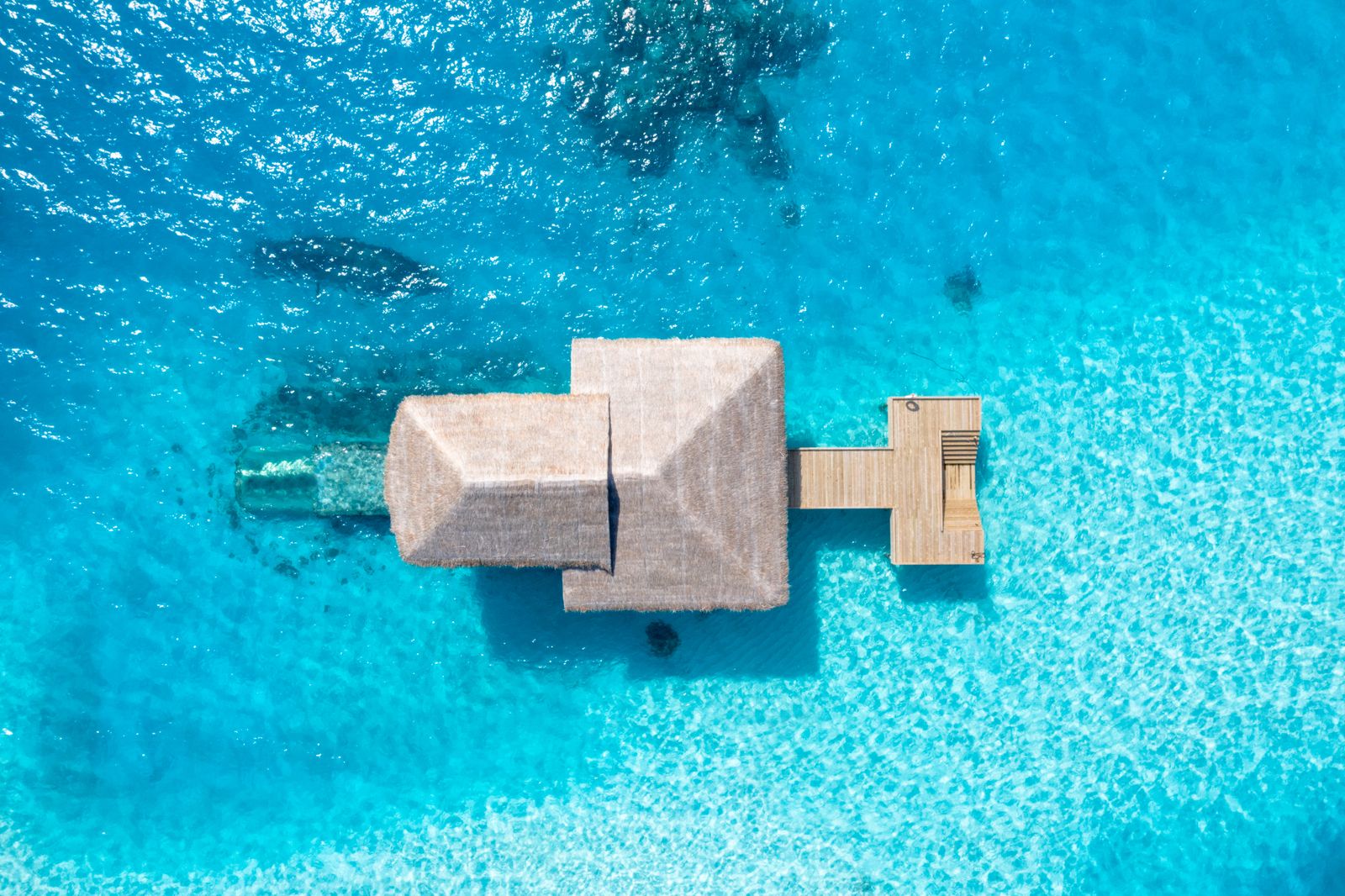 Maldives bungalow over reef